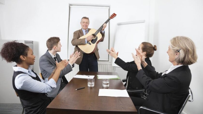 businessman-playing-guitar-in-business-meeting