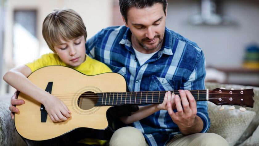 father-and-son-playing-a-guitar